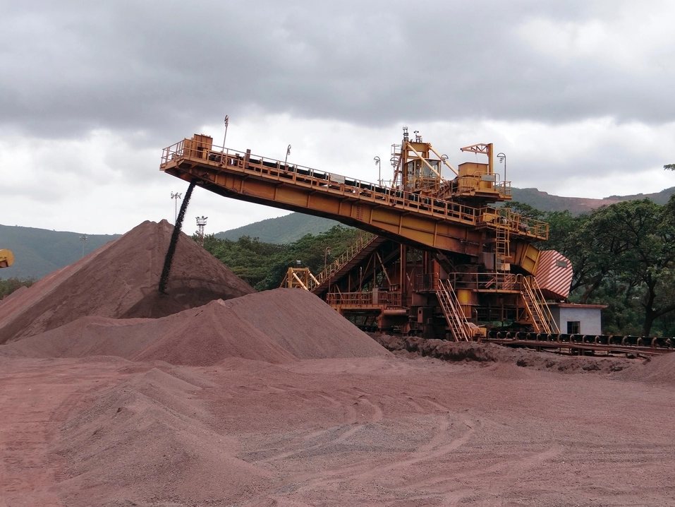 Stacker conveyor building an ore stockpile at a mine