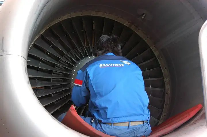 Technician working on a turbofan engine